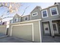 A charming exterior view showcasing the townhome's garage, front door, and a well-maintained facade at 11205 Holly St, Thornton, CO 80233