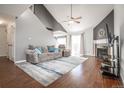 Bright living room with vaulted ceilings, fireplace, and sliding glass doors at 11205 Holly St, Thornton, CO 80233