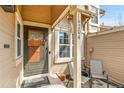 Inviting front porch with seating, address display, and a decorative front door at 14204 E Radcliff Cir, Aurora, CO 80015