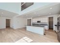 Open concept kitchen with a center island, modern appliances, and sleek cabinetry at 4652 Windmill Dr, Brighton, CO 80601