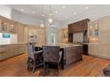 Spacious kitchen boasts a center island, wood floors, and custom cabinetry at 65 Royal Ann Dr, Englewood, CO 80111