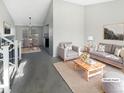 This is a staged living room featuring neutral tones, modern decor, and ample natural light at 2875 S Espana Ct, Aurora, CO 80013