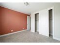 Cozy bedroom with plush carpet, closet, and an accent wall at 8791 Culebra Ct, Arvada, CO 80007