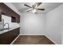 Dining room with hardwood floors, a ceiling fan, and a view to the kitchen at 7665 E Eastman Ave # 301A, Denver, CO 80231