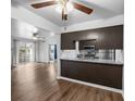 Open kitchen with granite countertops, stainless steel appliances, and hardwood floors at 7665 E Eastman Ave # 301A, Denver, CO 80231