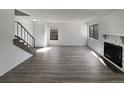 Spacious living room featuring hardwood floors, a fireplace, and natural light from large windows at 11813 Grant St, Northglenn, CO 80233