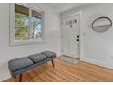 Cozy entryway features wood floors, a stylish bench, and a bright window for a welcoming ambiance at 4001 Wyandot St, Denver, CO 80211