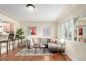 Cozy living room featuring a comfortable sectional, hardwood floors, and barstool seating at 4433 S Washington St, Englewood, CO 80113
