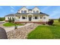 Inviting two-story home featuring a charming front porch, manicured lawn, and stone accents at 3973 Palmer Ridge Dr, Parker, CO 80134