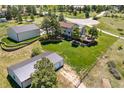 Aerial view of property with outbuildings, lush lawn, mature trees, and deck overlooking the scenic countryside at 9025 Rocky Mountain Ln, Parker, CO 80138