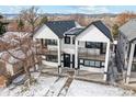 Stylish two-story townhome with balconies, black accents, and fresh landscaping at 2321 S Galapago St, Denver, CO 80223