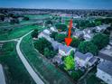 Stunning aerial view of home, showcasing landscaped yard and neighborhood amenities at dusk at 5163 E 123Rd Ct, Thornton, CO 80241