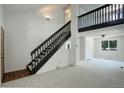 Bright, open living room with a staircase and large window at 5163 E 123Rd Ct, Thornton, CO 80241