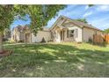 Well-manicured single Gathering home, featuring mature trees, and a lush lawn at 17499 E Whitaker Dr, Aurora, CO 80015