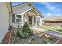 Charming home featuring a well-manicured garden, welcoming front porch and neutral siding at 17499 E Whitaker Dr, Aurora, CO 80015