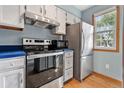 Kitchen featuring stainless steel appliances, white cabinets, and blue countertop at 1035 Milo Cir # B, Lafayette, CO 80026