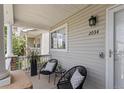 Charming front porch features seating and a view of the house number at 2034 Espana Way, Aurora, CO 80011