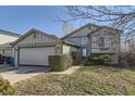 Charming home exterior with a two-car garage, walkway, and landscaped front yard at 18890 E Carmel Cir, Aurora, CO 80011