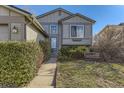 Inviting home with a charming exterior, well-maintained lawn and landscaped front yard at 18890 E Carmel Cir, Aurora, CO 80011