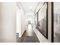 Inviting home hallway with hardwood floors, neutral paint, recessed lighting, and modern décor at 3379 N Denali St, Aurora, CO 80019