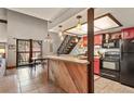 View of the kitchen featuring black appliances, breakfast bar, and dining area with large windows at 107 N Harris St # 306, Breckenridge, CO 80424