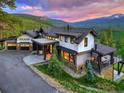 Charming exterior with beautiful stonework, multiple levels, and outdoor seating areas overlooking the mountains at 2300 Boreas Pass Rd, Breckenridge, CO 80424