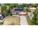 Aerial view of a two-story home with an attached garage, solar panels and landscaping at 1261 Eagle St, Aurora, CO 80011