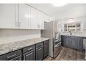 Well-lit kitchen featuring stainless steel appliances, gray cabinetry, and granite countertops at 8191 Tennyson St, Westminster, CO 80031