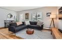 Modern living room with sectional sofa and wood floors at 7505 Robinson Way, Arvada, CO 80003