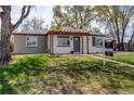 Inviting single-story home featuring a pergola-covered entry and a 'For Sale' sign in the front yard at 6220 W 11Th Pl, Lakewood, CO 80214