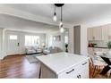 Open-concept living space featuring hardwood floors and lots of natural light at 6220 W 11Th Pl, Lakewood, CO 80214