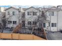 Townhome backyard features a privacy fence, a small patio, and trees for outdoor enjoyment and relaxation at 12327 E Tennessee Dr # 107, Aurora, CO 80012