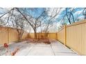 A small, fenced backyard with a concrete patio, providing a private outdoor space at 12327 E Tennessee Dr # 107, Aurora, CO 80012
