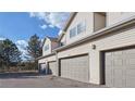 Exterior of townhomes with attached garages and light siding at 12327 E Tennessee Dr # 107, Aurora, CO 80012