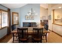 Spacious dining room with wood floors, wainscotting, and contemporary chandelier at 6073 W Adriatic Pl, Lakewood, CO 80227