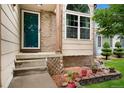 Welcoming entrance with brick accents, steps leading to the front door, and potted plants enhancing the curb appeal at 7796 Xavier Ct, Westminster, CO 80030