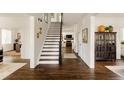 Elegant entryway with hardwood floors, staircase, and view of the living room at 301 Fairfax St, Denver, CO 80220