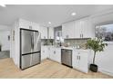 Bright kitchen with white cabinets, stainless steel appliances, and patterned backsplash at 1173 Xenon St, Golden, CO 80401