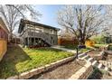 Backyard with nice lawn, stairs, garden area, and room for outdoor activities at 3233 Meade St, Denver, CO 80211