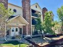 Well-maintained condominium building features multiple levels, manicured landscaping, and inviting entrance at 15911 E Dakota Pl # 301, Aurora, CO 80017