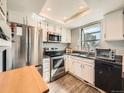 Bright kitchen features white cabinets, stainless steel appliances, and granite countertops at 15911 E Dakota Pl # 301, Aurora, CO 80017