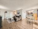 Inviting living room with hardwood floors and open concept kitchen/dining area at 15911 E Dakota Pl # 301, Aurora, CO 80017
