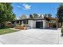 Attractive home boasts a new driveway, carport, and well-maintained landscaping at 6538 S Lee Ct, Centennial, CO 80121