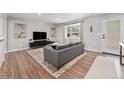 Bright living room with hardwood floors, modern furniture, and a large bay window at 6538 S Lee Ct, Centennial, CO 80121
