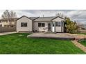Spacious backyard featuring a concrete patio area and lush green lawn perfect for outdoor entertaining at 2132 Boise Ct, Longmont, CO 80504