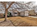 Pleasant home exterior featuring neutral tones, landscaping, and a two-car garage at 2132 Boise Ct, Longmont, CO 80504