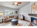 Cozy living room featuring a stone fireplace, hardwood floors, and a comfortable seating area at 2132 Boise Ct, Longmont, CO 80504