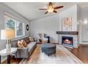Relaxing living room featuring a stone fireplace, neutral colors, and hardwood floors at 2132 Boise Ct, Longmont, CO 80504