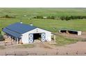 Well-maintained barn with ample space and a functional design, perfect for livestock or storage at 10515 Lucas Ave, Franktown, CO 80116