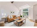 Bright living room with vaulted ceilings, modern furnishings, and large windows at 9948 King St, Westminster, CO 80031